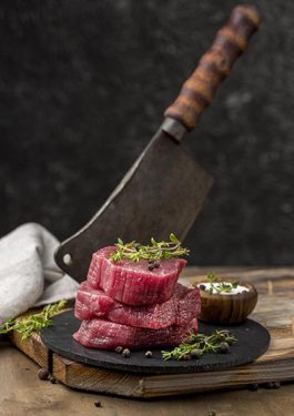 high-angle-meat-slate-with-herbs-cleaver